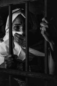 grayscale photography of woman inside jail